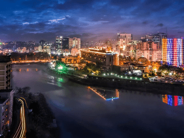 Dhaka city skyline at night representing why study MBBS in Bangladesh including affordable fees, English medium education, low living cost, easy travel from India, and student friendly environment.