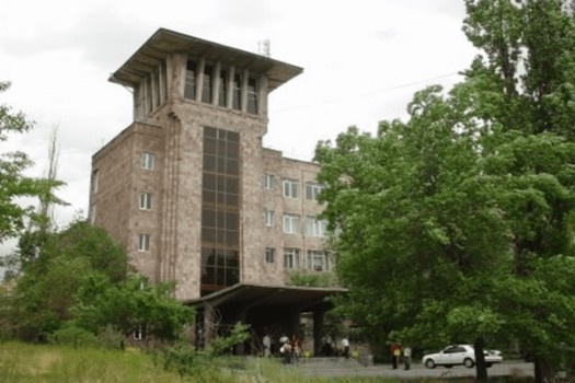 Campus building of Yerevan Haybusak University surrounded by greenery, highlighting affordable MBBS education, experienced faculty, and modern infrastructure for medical students.