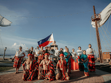 Students in traditional Filipino attire with national flag representing cultural diversity in Philippines, highlighting inclusive environment, global exposure, and friendly atmosphere for MBBS students.