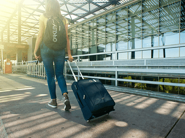 Student walking with suitcase symbolizing Asian Medical Institute hostel and accommodation with secure campus, free WiFi, separate hostels, furnished rooms, mess facility, and essential amenities for students.