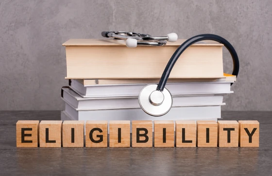 Eligibility for MBBS abroad showing medical books, stethoscope, and eligibility blocks, representing guidance from a trusted MBBS abroad consultancy on admission requirements and study costs.