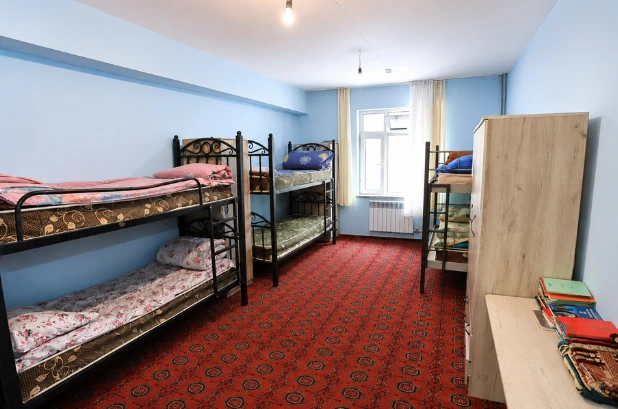 Furnished hostel room at Osh State Medical University with bunk beds, wardrobes, heating, Wi-Fi, security and shared facilities for international students.